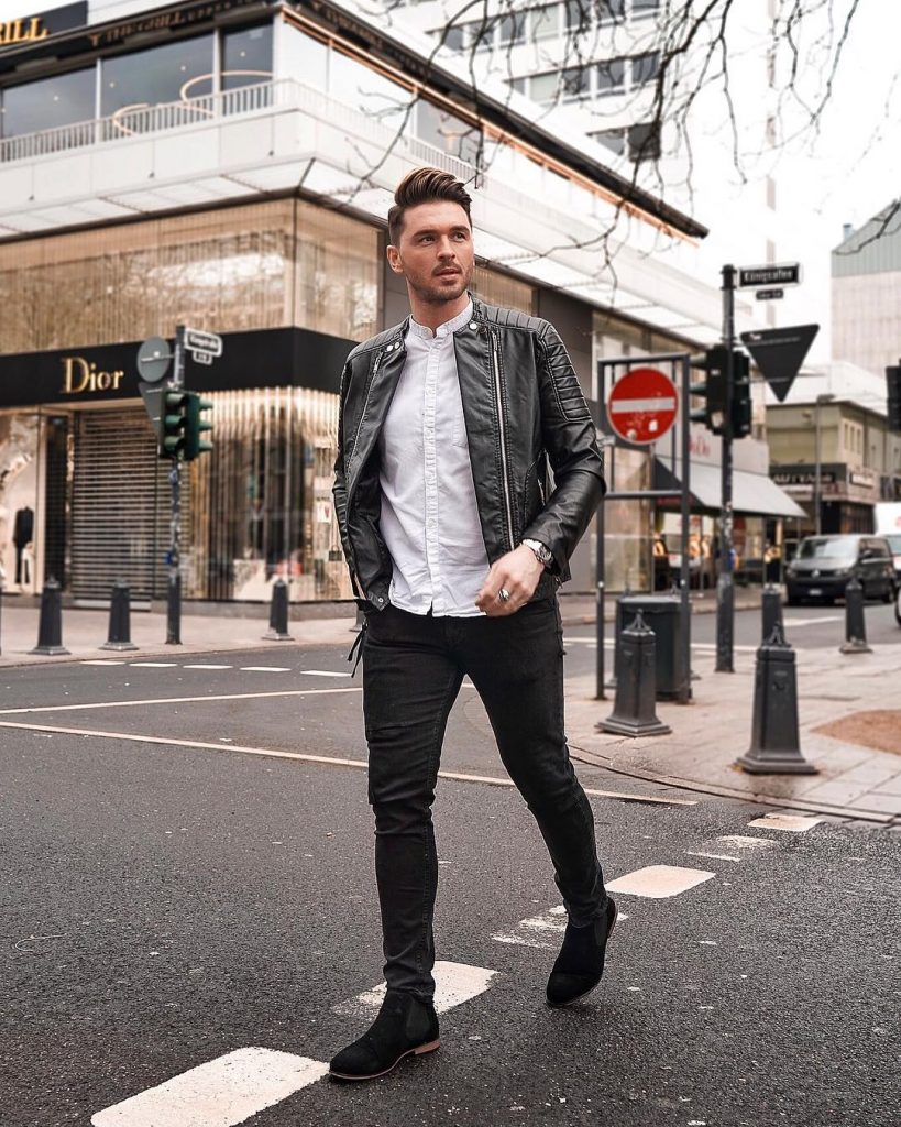 Black leather jacket, mandarin collar white shirt, black jeans and, Chelsea boots