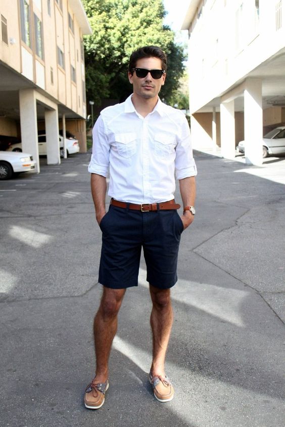 White shirt, dark blue short pants, brown belt, boat shoes