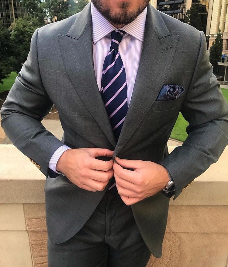 Dark gray checked suit, purple pinstripe shirt, and pinstripe tie