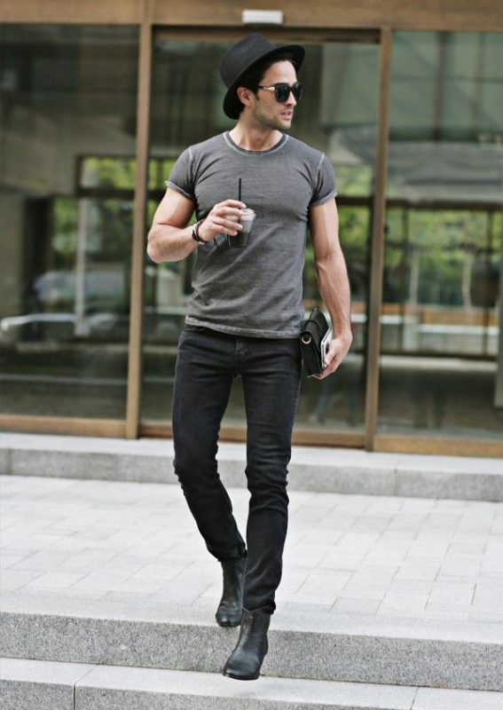 Gray t-shirt, dark color jeans, black hat and Chelsea boots
