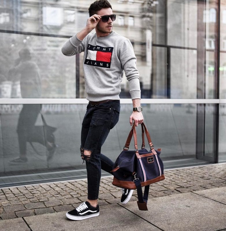 Gray printed sweater, black jeans, sunglasses, black sneaker and hand bag