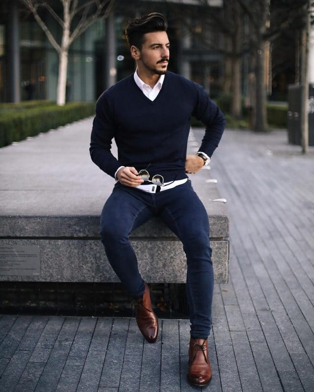 Blue sweater, white shirt, blue jeans and chukka boots