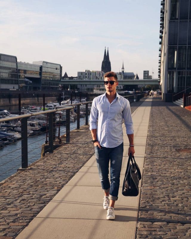 Checked shirt, blue jeans, white sneaker and handbag