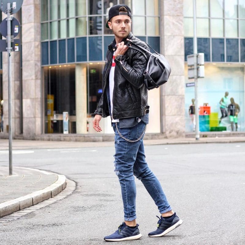 Leather jacket, tee, jeans, sneaker, snapback hat.