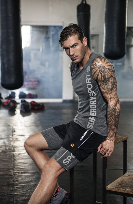 Gray sleeveless muscle tee, sport pants and sport shoes