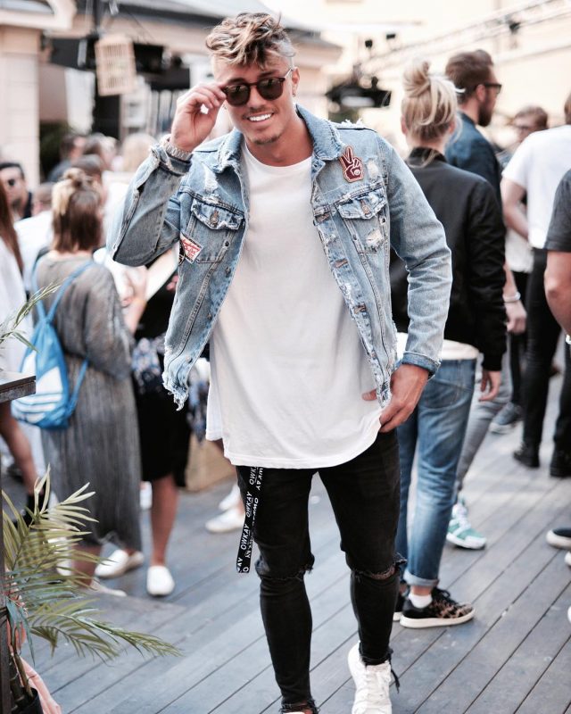 Blue denim jacket, white tee, black ripped jeans.