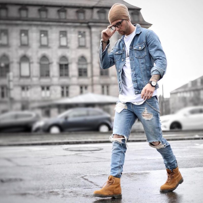 Brown beanie hat, blue denim jacket, white print tee, blue ripped jeans, brown boots