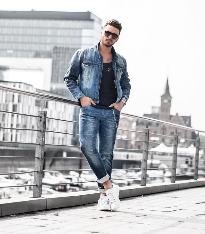 Black singlet, blue denim jacket, blue jeans, white sneaker