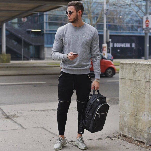 Gray sweater, black sport pants, training shoes, backpack 1