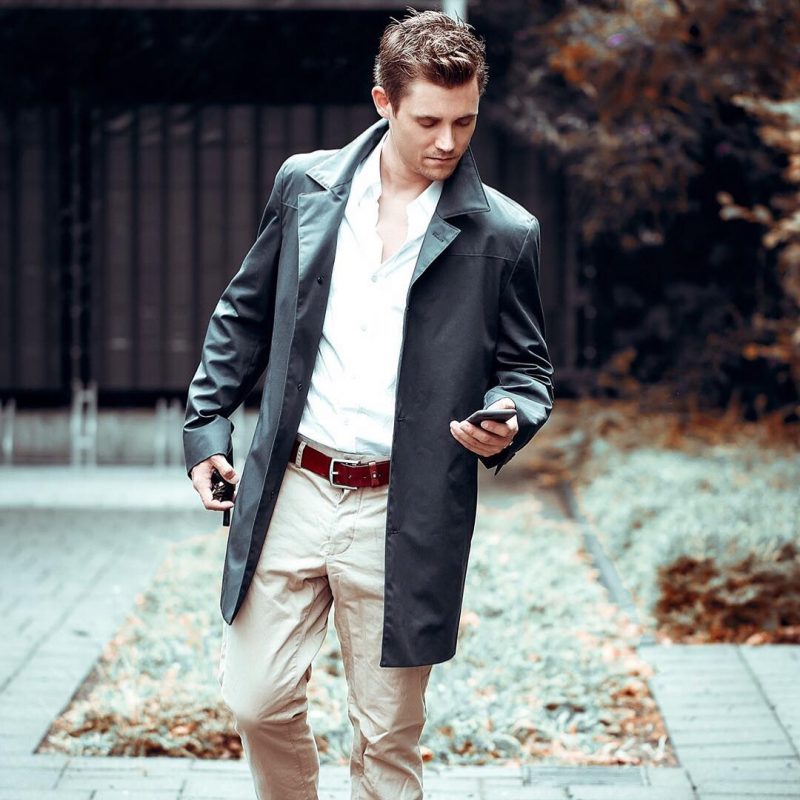Black trench coat, white shirt, brown leather belt, khaki pants 1