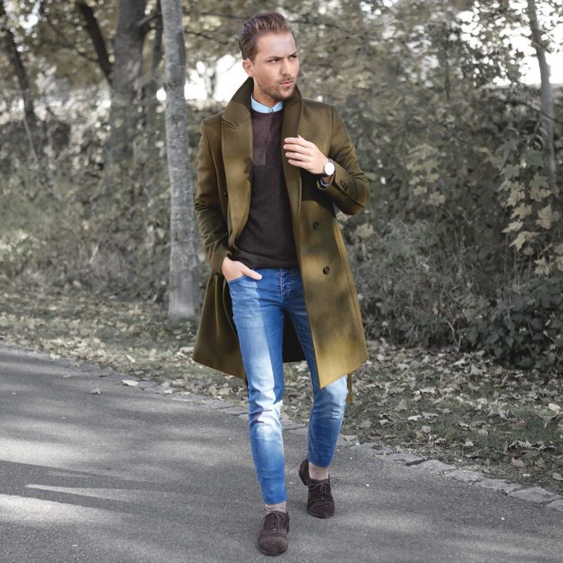 Olive green overcoat, brown sweater, blue jeans 1