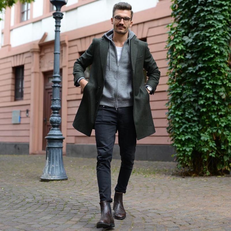 Black overcoat, grey hoodie jacket, white singlet, dark brown Chelsea boots 1