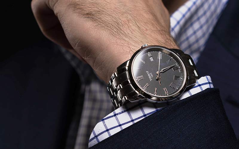 man wearing a Tissot watch on his wrist